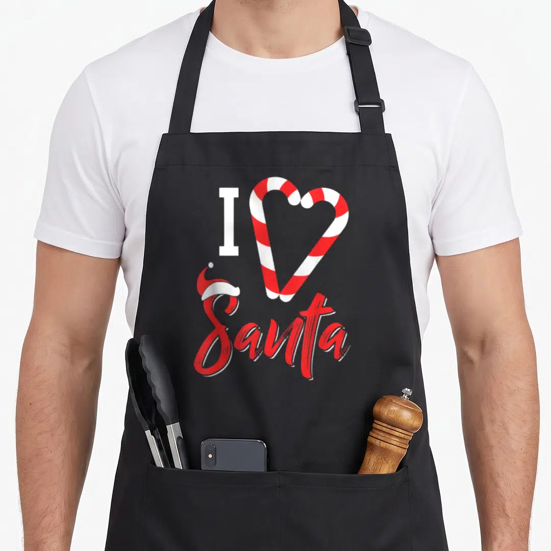 Christmas santa candy cane apron - I Santa text with two red white candy canes forming a heart and a small hat on the S — shown on a black cotton canvas apron against a white background