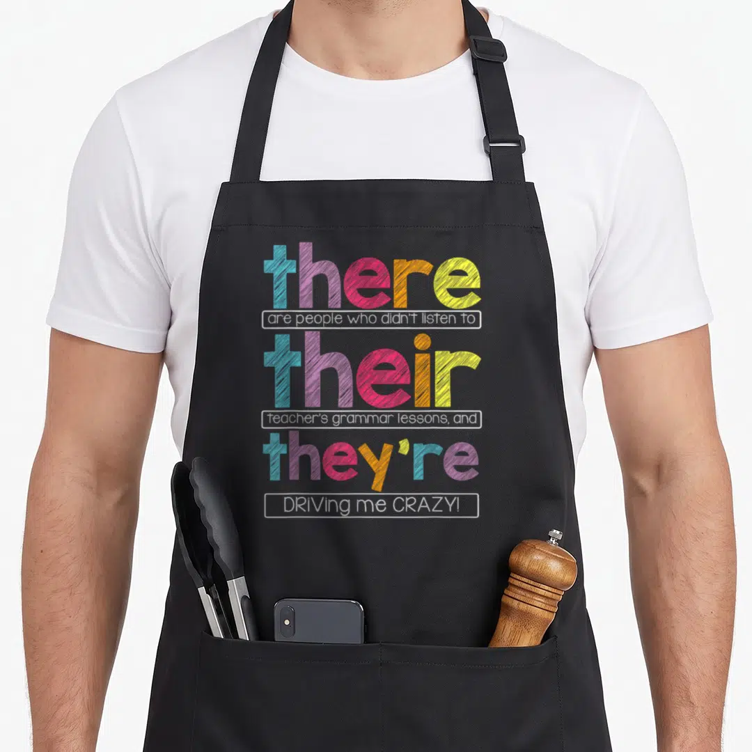 Their teacher apron - Stacked colorful text reading there are people who didn't listen to their teacher's grammar — shown on a black cotton canvas apron against a white background