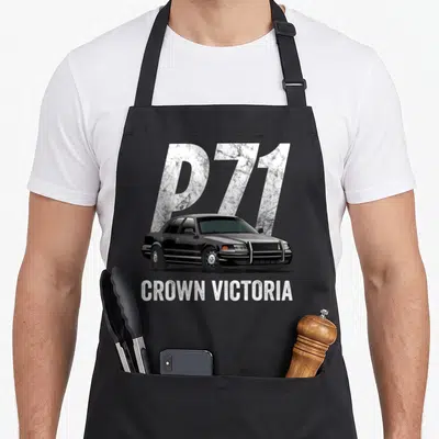 Car police apron - Black Crown Victoria sedan with large silver P71 background text and white CROWN VICTORIA label below — shown on a black cotton canvas apron against a white background