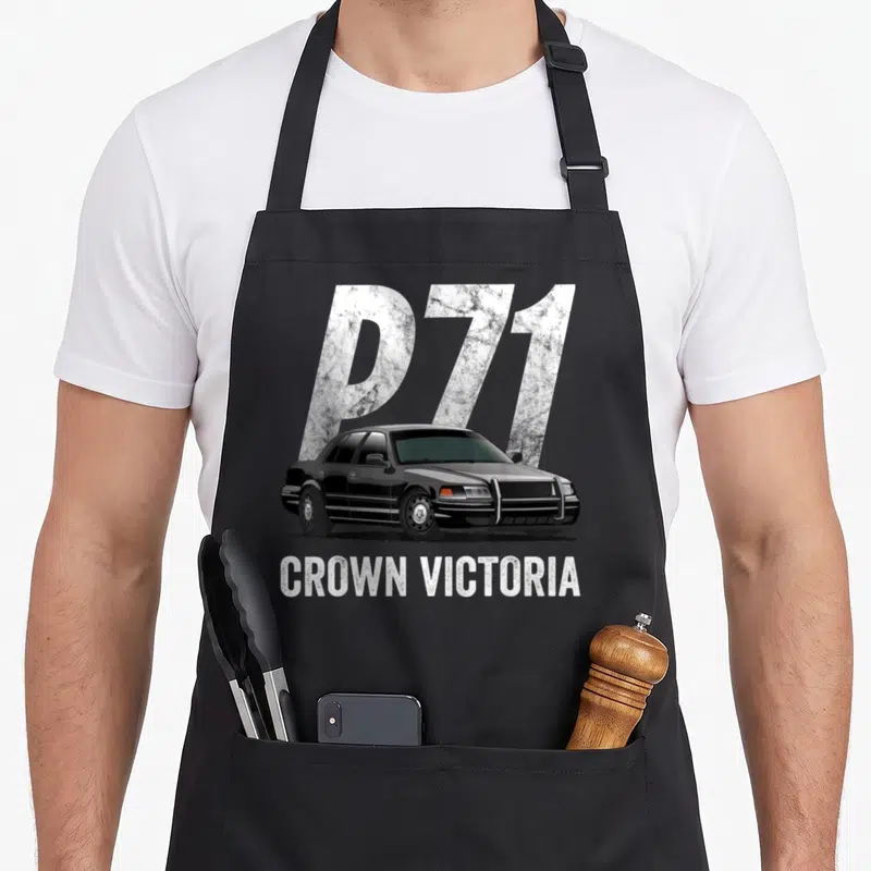 Car police apron - Black Crown Victoria sedan with large silver P71 background text and white CROWN VICTORIA label below — shown on a black cotton canvas apron against a white background