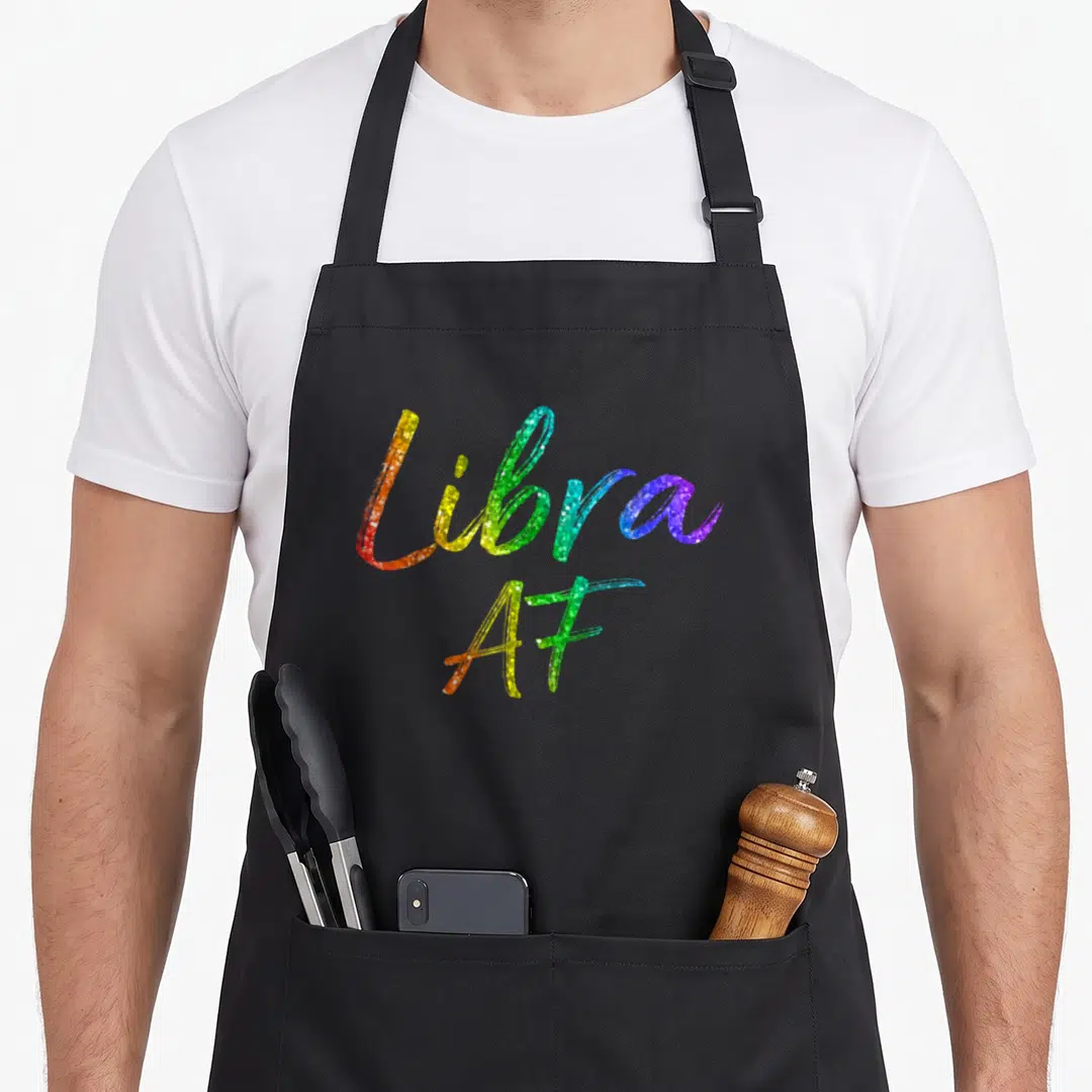 September october birthday apron - Rainbow gradient text reading Libra AF in cursive script — shown on a black cotton canvas apron against a white background