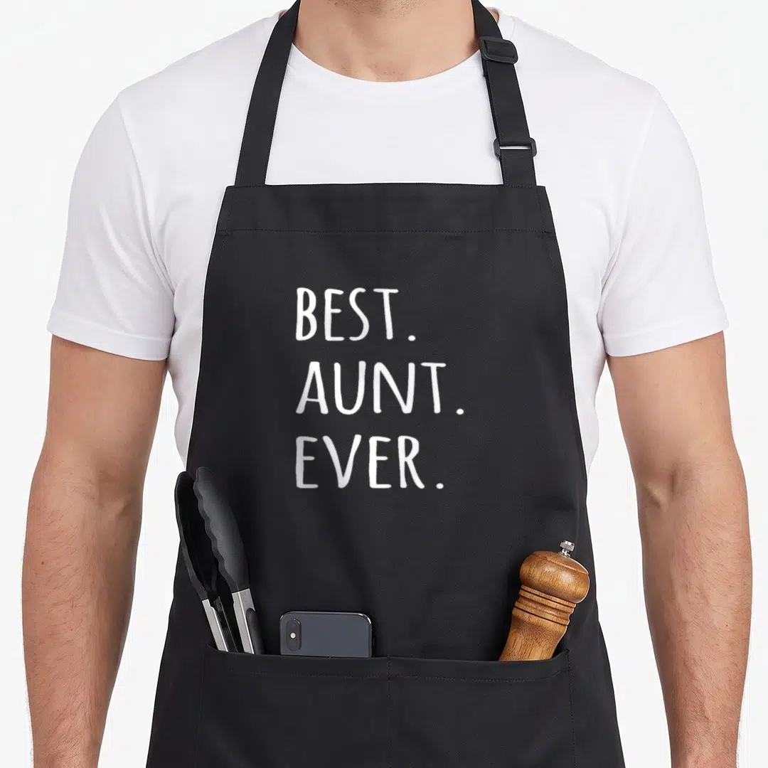 Auntie aunt apron - White stacked text reading Best. Aunt. Ever. on dark grey background — shown on a black cotton canvas apron against a white background