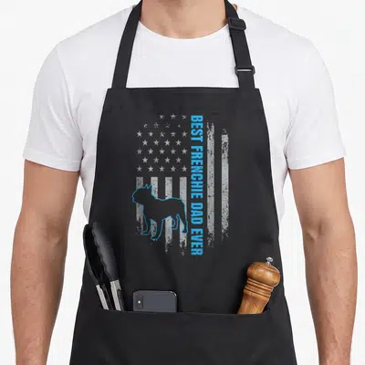 Frenchie french american flag apron - Vertical Best Frenchie Dad Ever text next to blue outline Frenchie — shown on a black cotton canvas apron against a white background