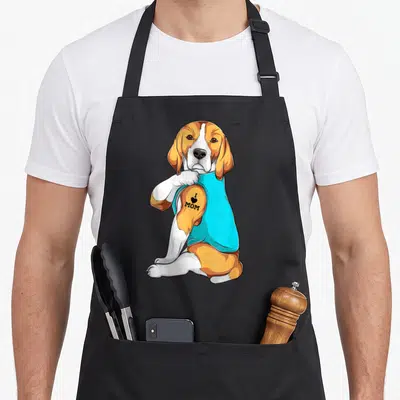 Vintage dog beagle apron - Cartoon beagle in cyan shirt showing I Love Mom tattoo on arm — shown on a black cotton canvas apron against a white background