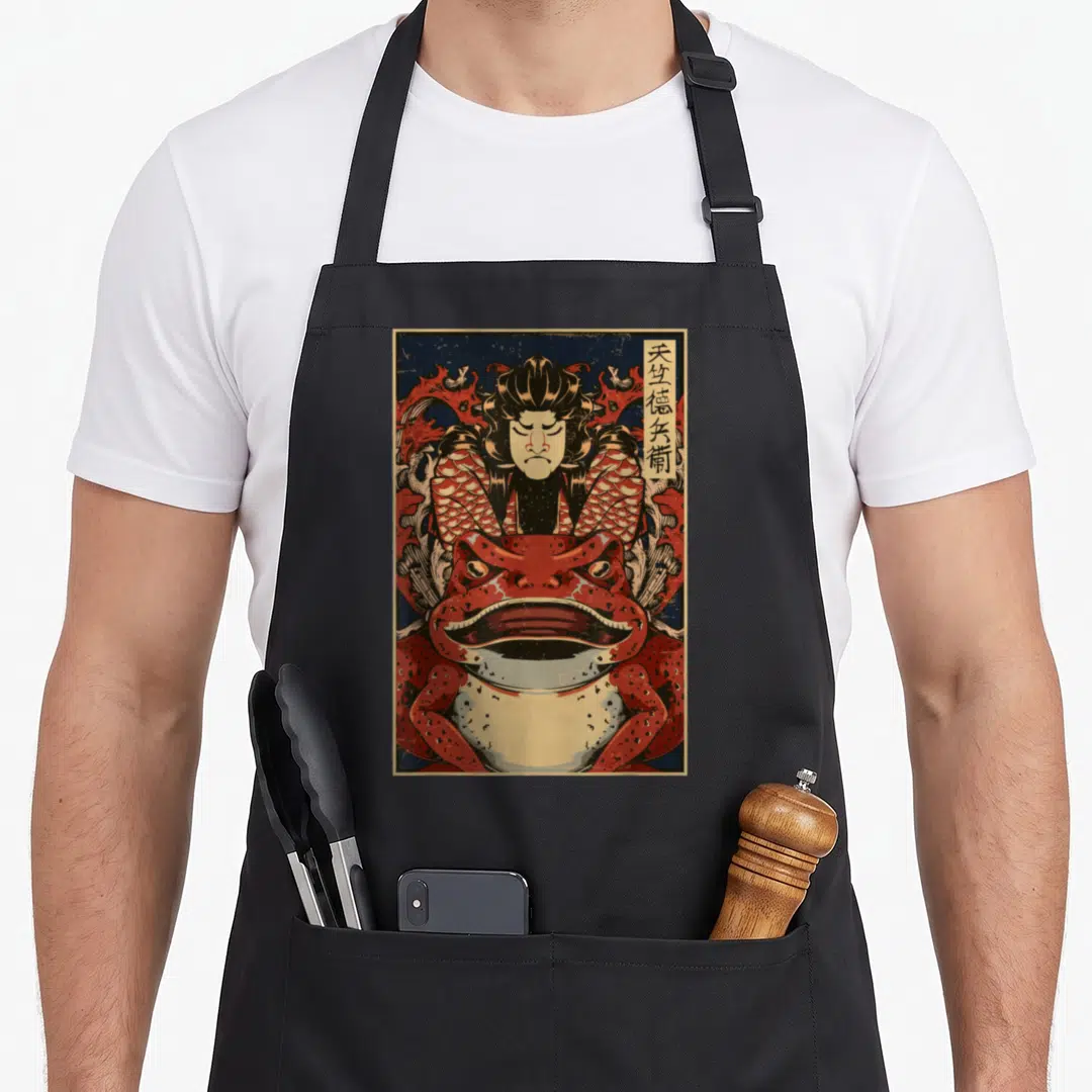 Japanese blocker apron - Red frog and figure with vertical Japanese text in retro art style — shown on a black cotton canvas apron against a white background