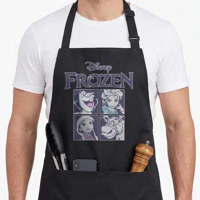 Blue character aprons - Stacked Disney FROZEN logo above four cartoon portraits in purple and white grid layout — shown on a black cotton canvas apron against a white background