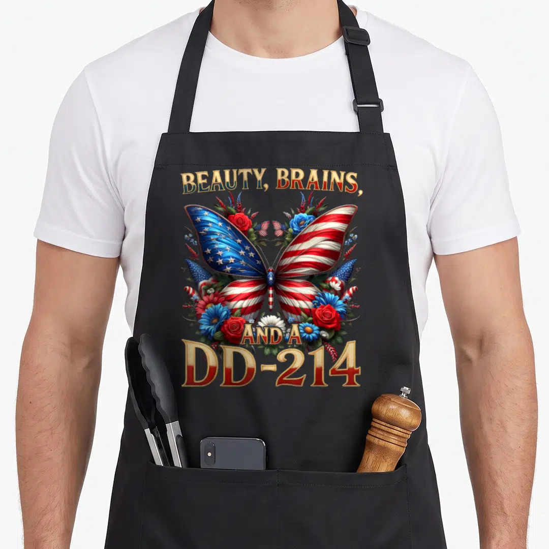 Veteran floral apron - Butterfly with flag wings surrounded by flowers and dd-214 text in red white blue gold — shown on a black cotton canvas apron against a white background