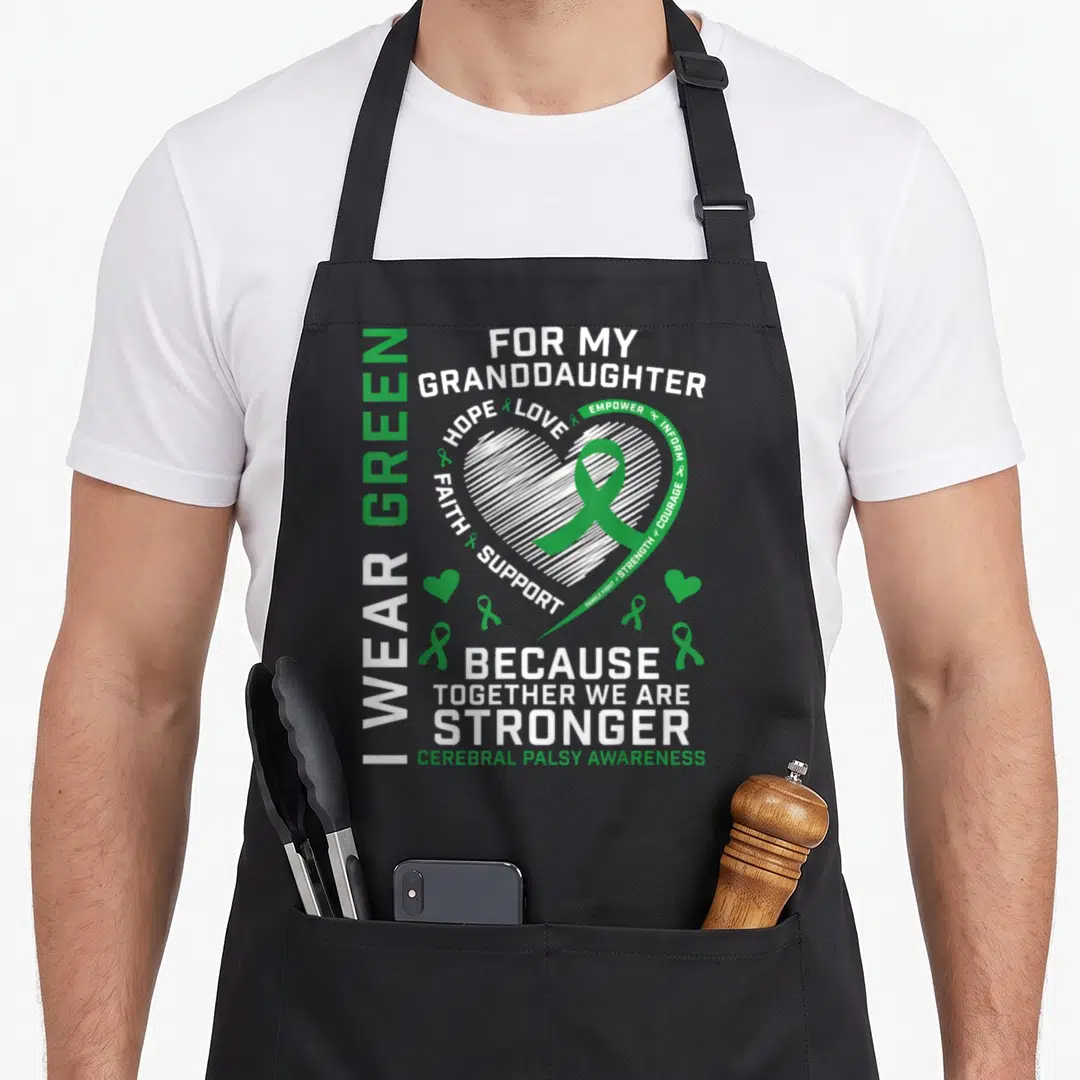 Grandpa grandma granddaughter aprons - I Wear Green For My Granddaughter Cerebral Palsy Awareness text with white heart — shown on a black cotton canvas apron against a white background