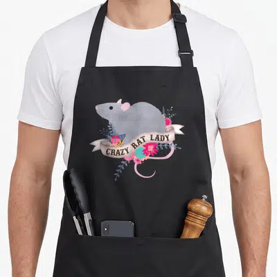 Rat pet apron for women - Watercolor grey rat with CRAZY RAT LADY banner and pink blue beige flowers — shown on a black cotton canvas apron against a white background