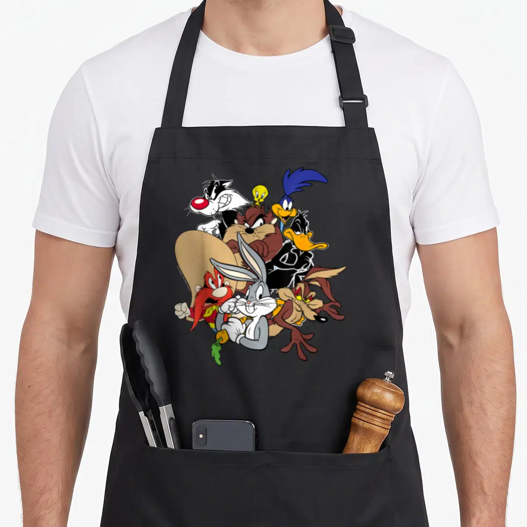 Funny main character aprons - Cluster of Looney Tunes cartoon characters in grey brown yellow and blue overlapping — shown on a black cotton canvas apron against a white background