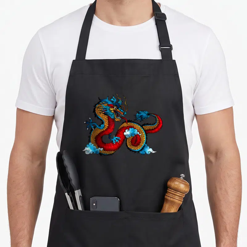 Chinese beautiful apron - Coiled red and blue dragon with gold scales and white clouds in cartoon style — shown on a black cotton canvas apron against a white background
