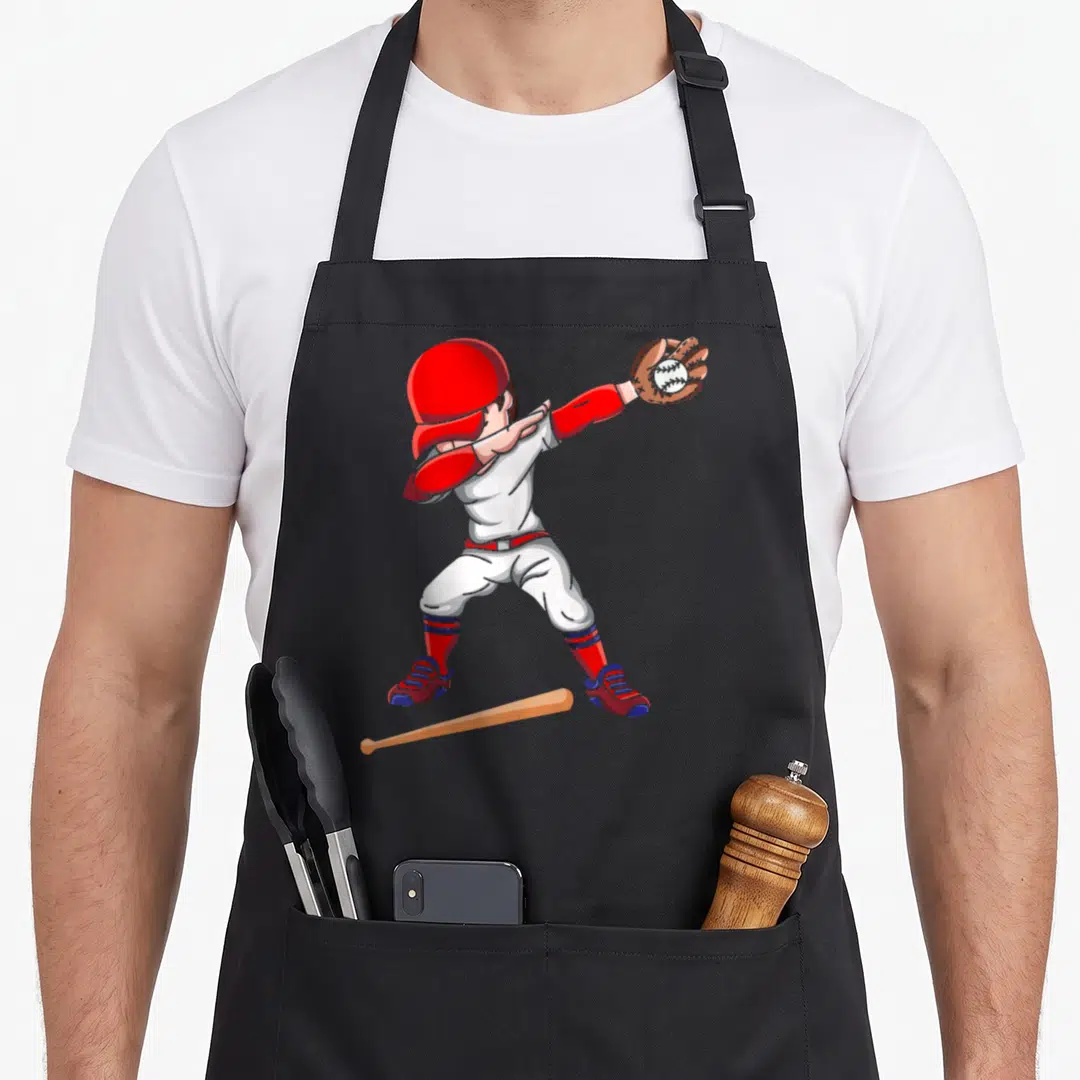 Baseballer baseball apron - Cartoon baseball player in red white blue brown catching ball with bat on ground — shown on a black cotton canvas apron against a white background