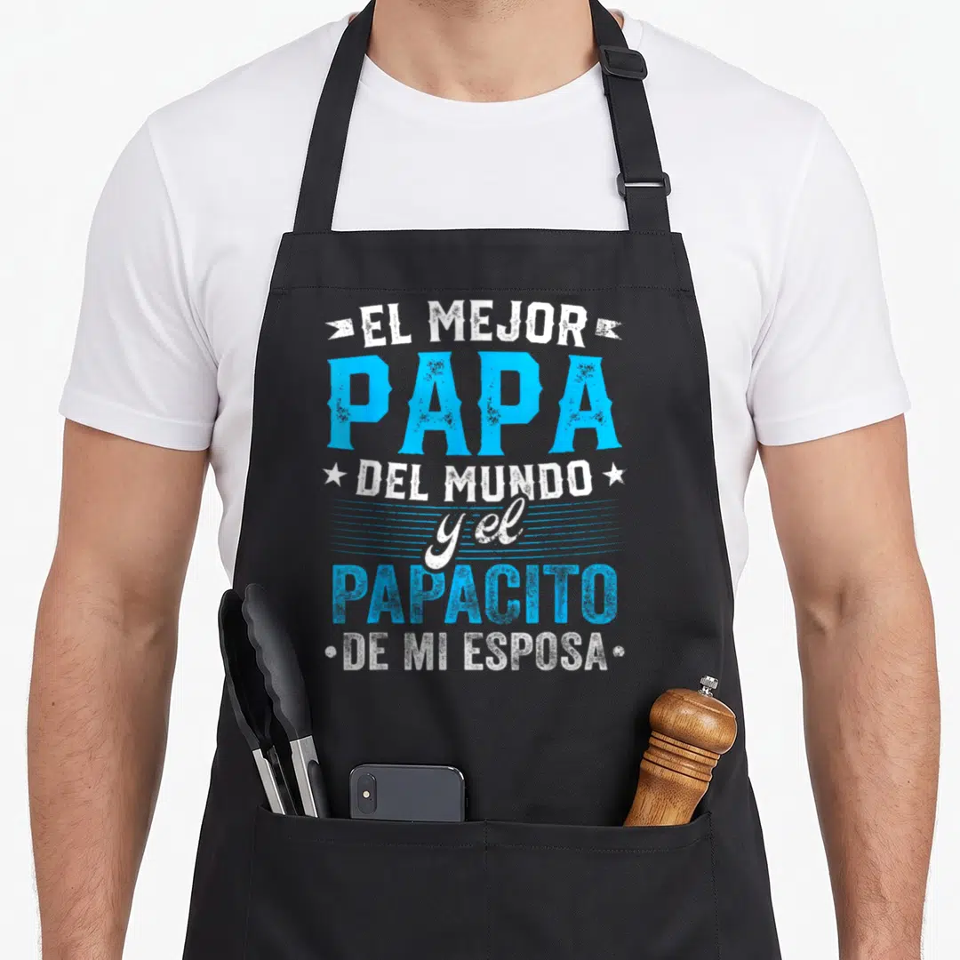 Del papa apron - Blue and white stacked Spanish text EL MEJOR PAPA DEL MUNDO with stars and ribbons — shown on a black cotton canvas apron against a white background