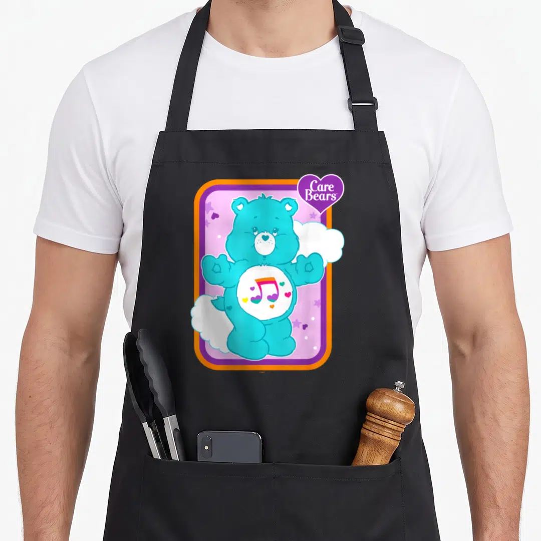 Heartsong bear apron - Turquoise bear with rainbow musical note inside purple and orange frame — shown on a black cotton canvas apron against a white background
