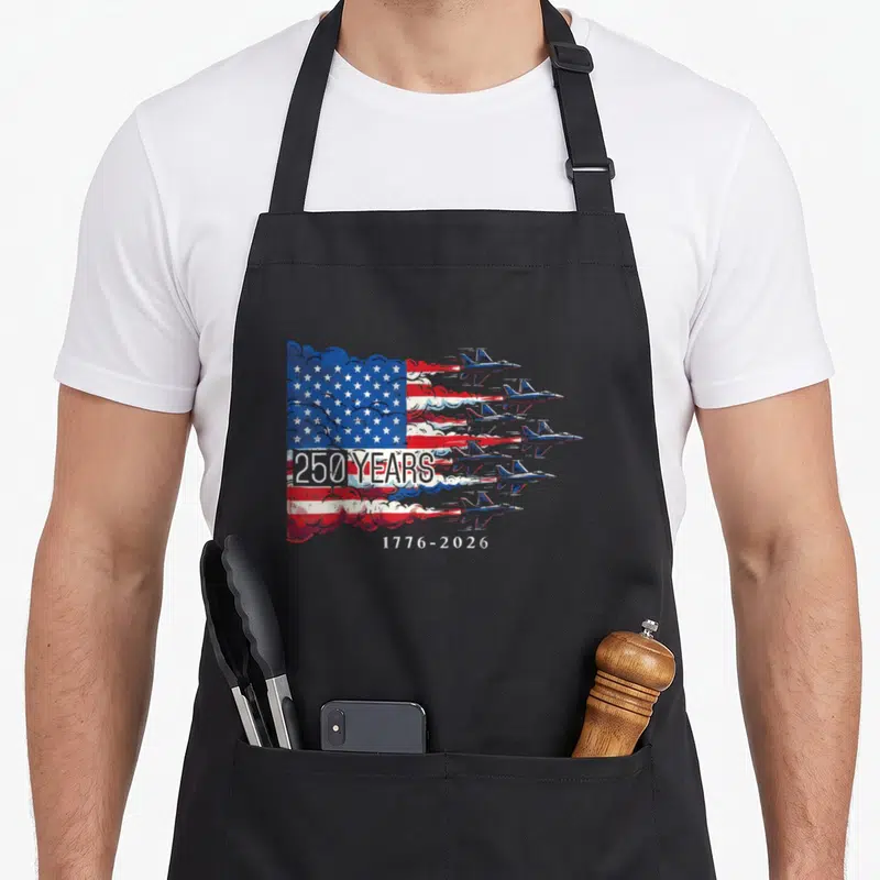 Anniversary flag 4th of july apron - Six jets forming US flag smoke trails with 250 years 1776-2026 text — shown on a black cotton canvas apron against a white background