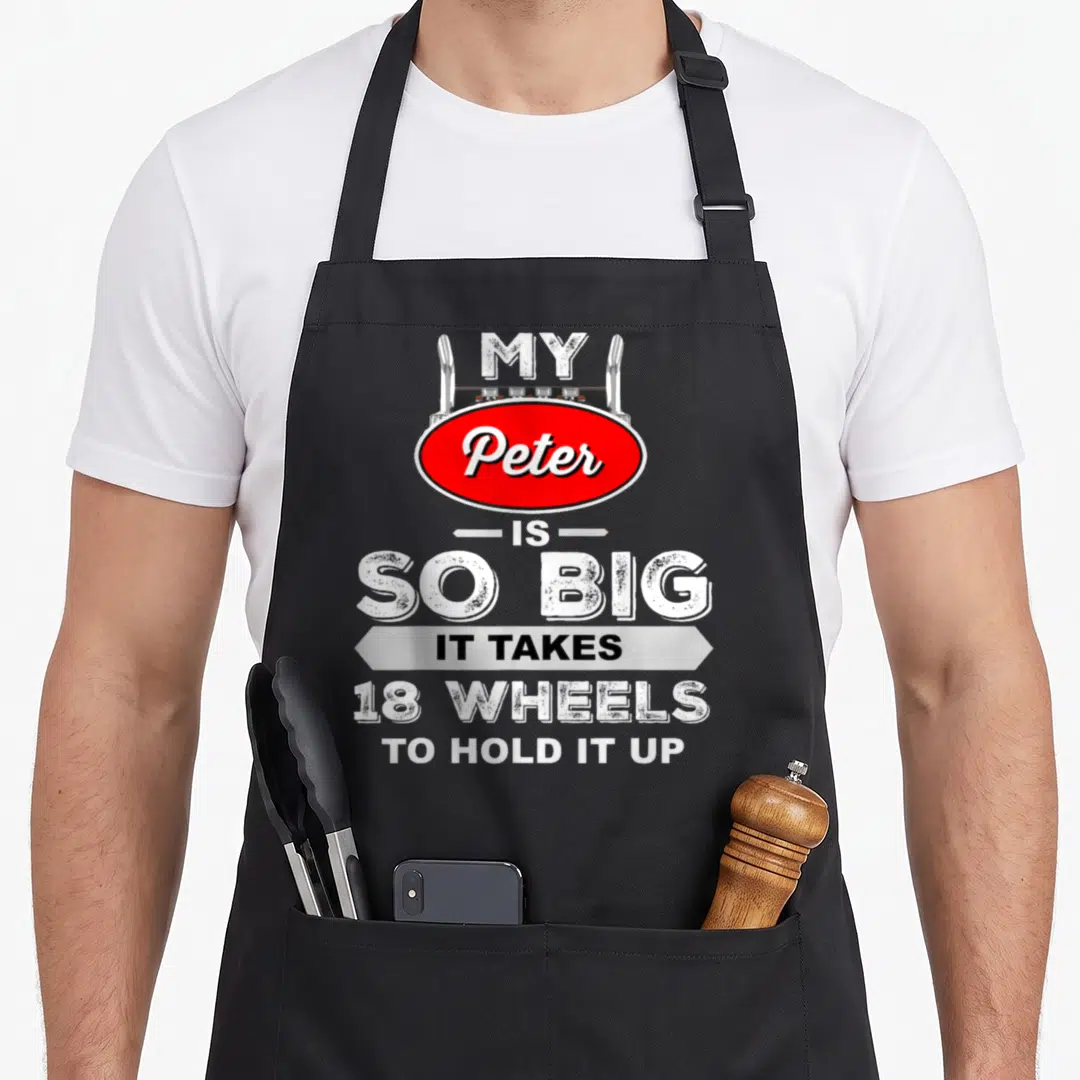 Peter truck apron - Red oval Peter sign and stacked white text reading My Peter is So Big It Takes 18 Wheels to Hold it — shown on a black cotton canvas apron against a white background