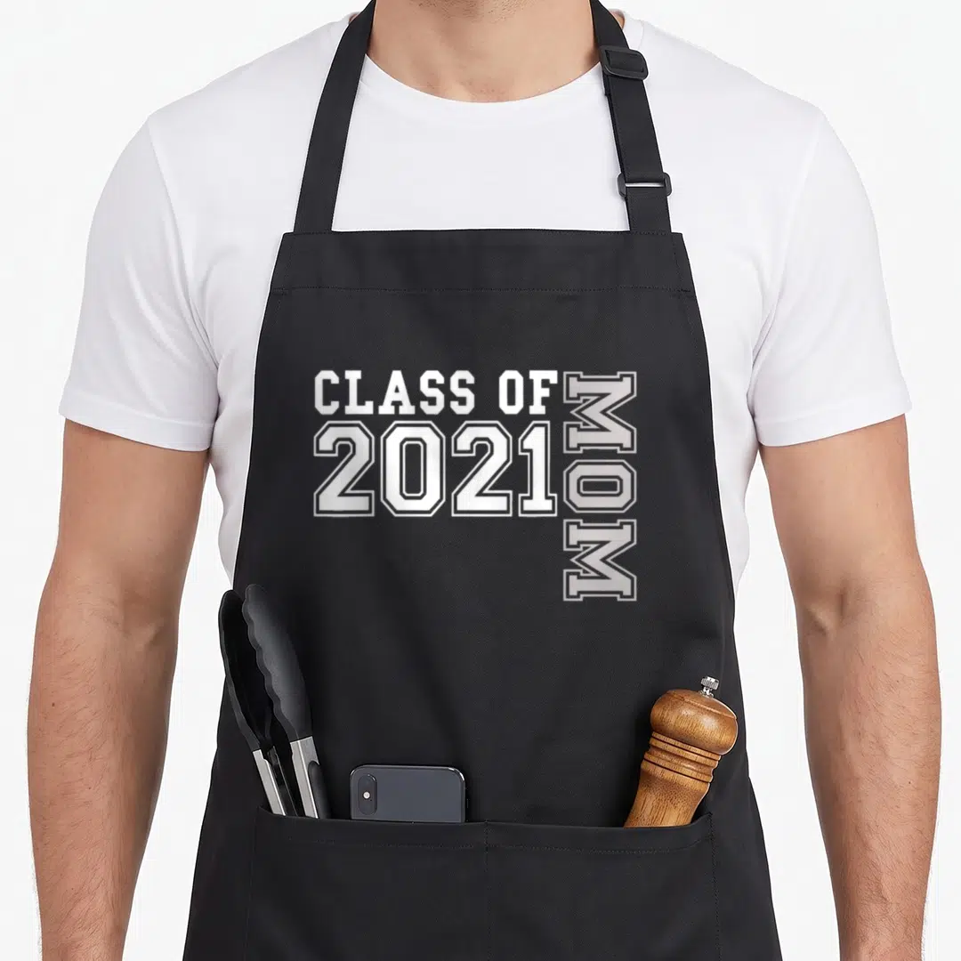 Senior family aprons - White and grey text reading Class of 2021 Mom with rotated vertical lettering — shown on a black cotton canvas apron against a white background