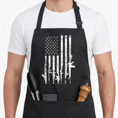 Distressed 2nd apron - White distressed USA flag with rifle silhouette stripes on black apron — shown on a black cotton canvas apron against a white background