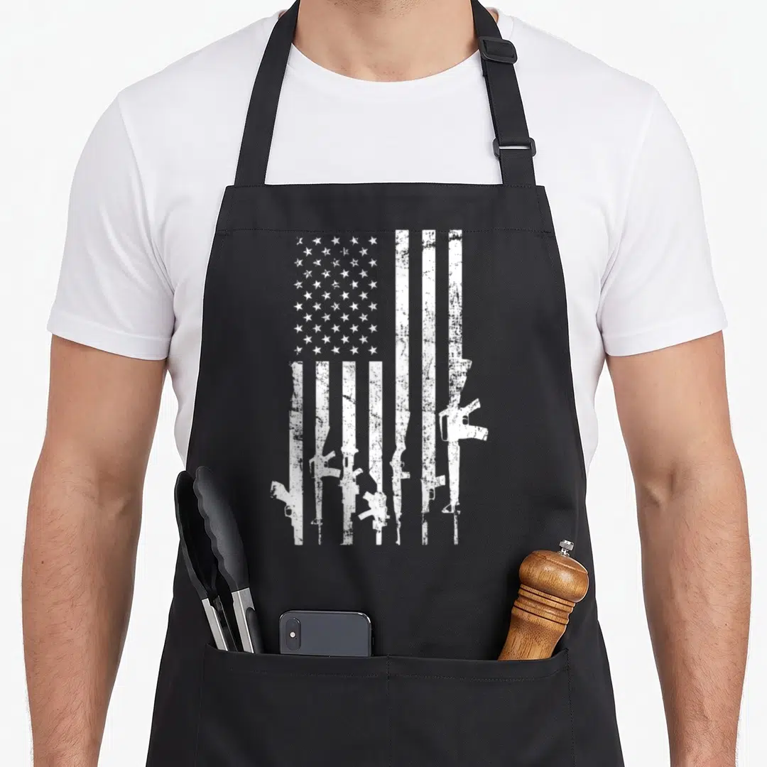 Distressed 2nd apron - White distressed USA flag with rifle silhouette stripes on black apron — shown on a black cotton canvas apron against a white background