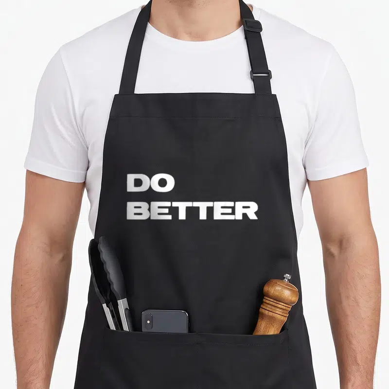 Entrepreneur have better apron - White DO BETTER stacked text on dark background — shown on a black cotton canvas apron against a white background