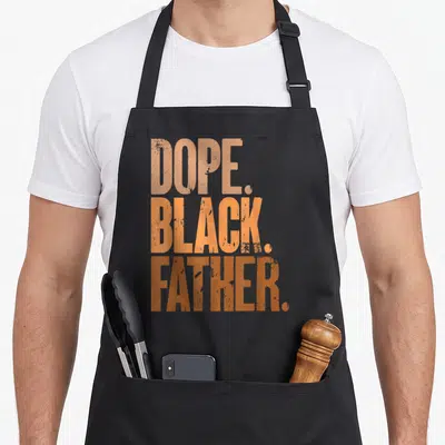 Dope father day apron - Stacked orange text reading DOPE. BLACK. FATHER. in distressed block font — shown on a black cotton canvas apron against a white background