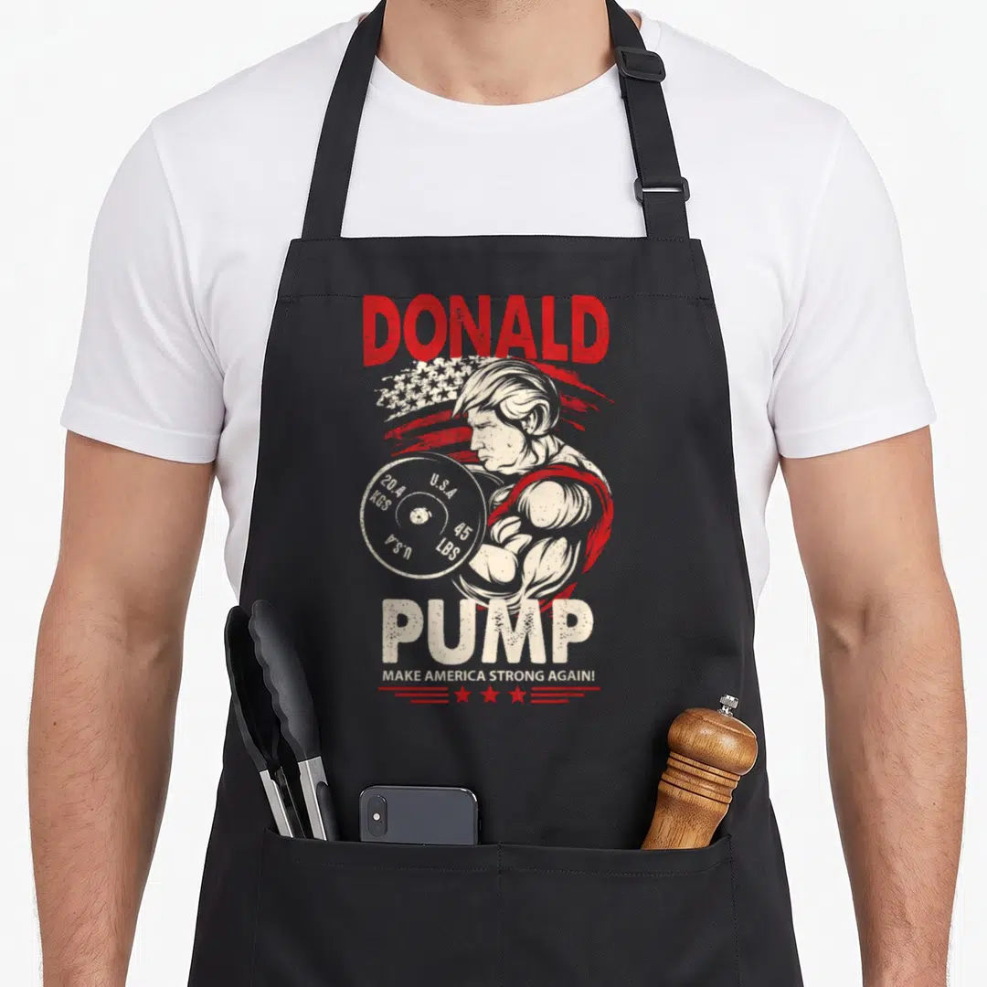 Donald gym class apron - Distressed red and white graphic of a man lifting a 45 lb weight plate with bold lettering — shown on a black cotton canvas apron against a white background