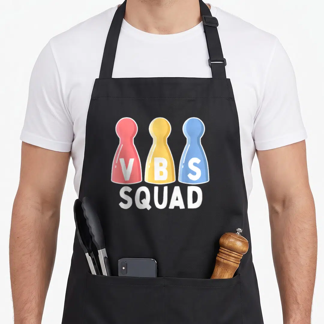 Vbs game aprons - Three red yellow and blue game pawns with VBS letters and SQUAD text below — shown on a black cotton canvas apron against a white background