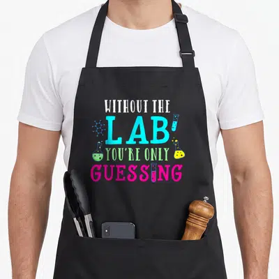 Phlebotomist microbiologist apron - Stacked text Without The Lab You're Only Guessing with molecule, flasks, and test — shown on a black cotton canvas apron against a white background