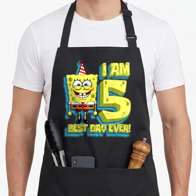 Cute squarepant birthday apron - SpongeBob SquarePants wearing a party hat next to a large yellow number 5 and text I — shown on a black cotton canvas apron against a white background