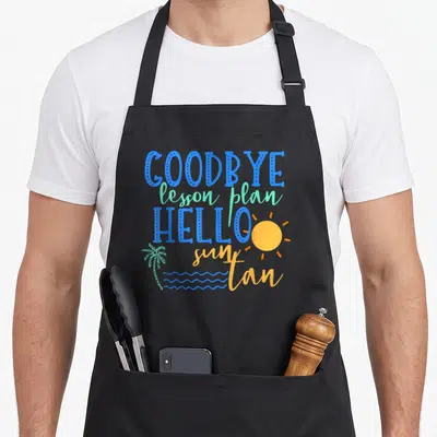 Vacation teacher apron - GOODBYE lesson plan HELLO sun tan text with palm tree, sun, and waves in blue green orange — shown on a black cotton canvas apron against a white background