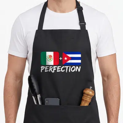 Cuban mexican apron - Two flags with plus sign and text PERFECTION below on black apron — shown on a black cotton canvas apron against a white background