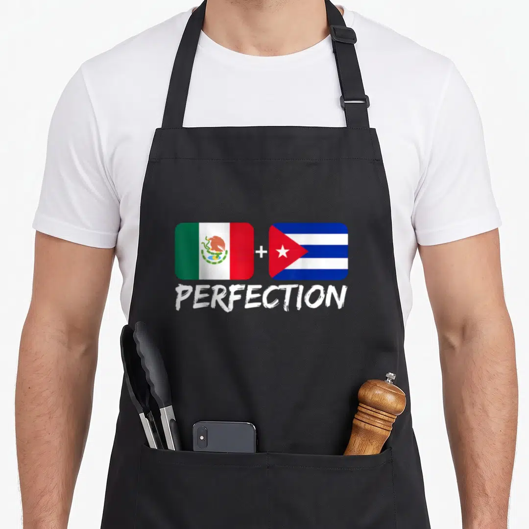 Cuban mexican apron - Two flags with plus sign and text PERFECTION below on black apron — shown on a black cotton canvas apron against a white background