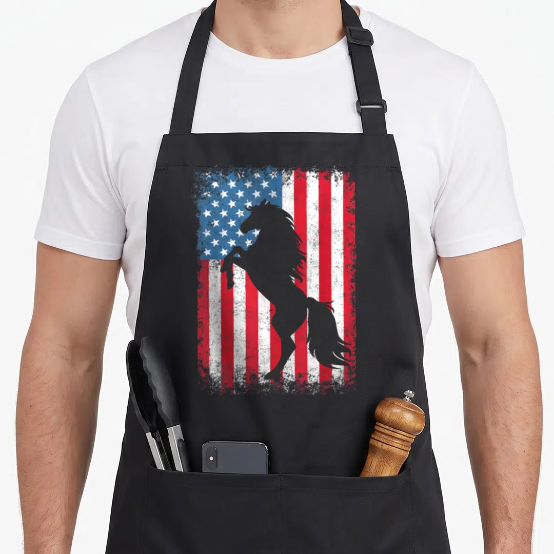 Horse 4th of july apron - Grey rearing horse silhouette over distressed red white and blue stars and stripes flag — shown on a black cotton canvas apron against a white background