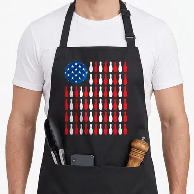 Bowler patriotic aprons - Blue bowling ball with white stars next to red and white pin stripes — shown on a black cotton canvas apron against a white background