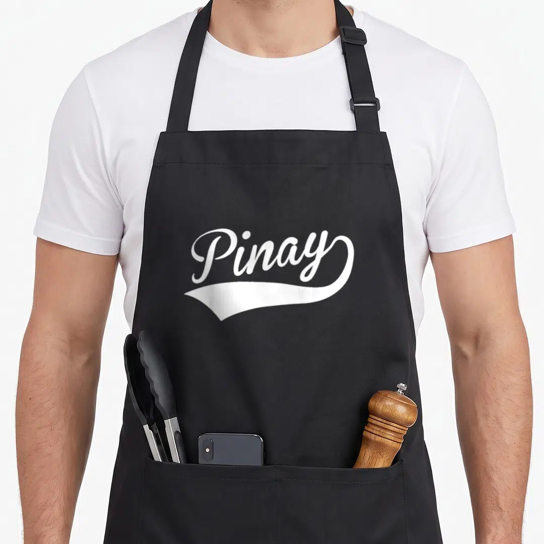 Filipina filipino apron - White Pinay text above a decorative swoosh on gray background — shown on a black cotton canvas apron against a white background