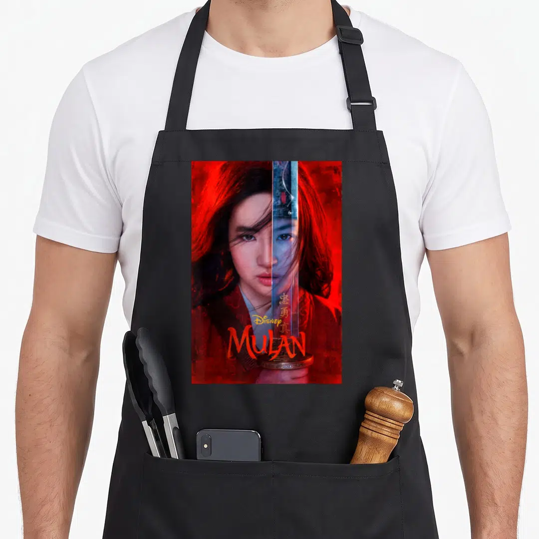 Live split apron - Woman holding vertical sword, red background, Disney MULAN text — shown on a black cotton canvas apron against a white background