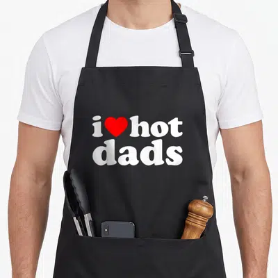 Vintage love hot apron - Red heart between i and hot above white dads text — shown on a black cotton canvas apron against a white background