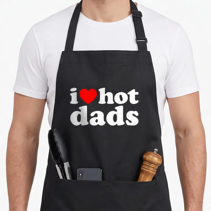 Vintage love hot apron - Red heart between i and hot above white dads text — shown on a black cotton canvas apron against a white background