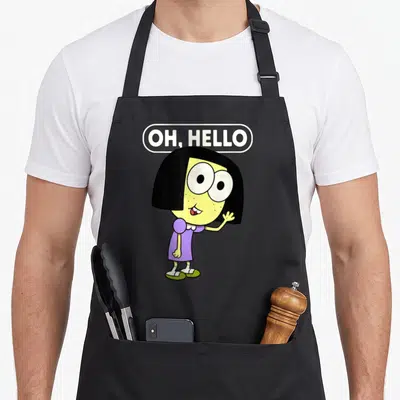Tilly hello apron - Cartoon girl with yellow skin and purple dress standing and waving under OH HELLO text — shown on a black cotton canvas apron against a white background