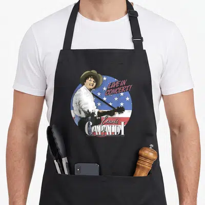 Americas new york apron - Lewis Capaldi LIVE IN CONCERT! graphic on black bib apron — shown on a black cotton canvas apron against a white background