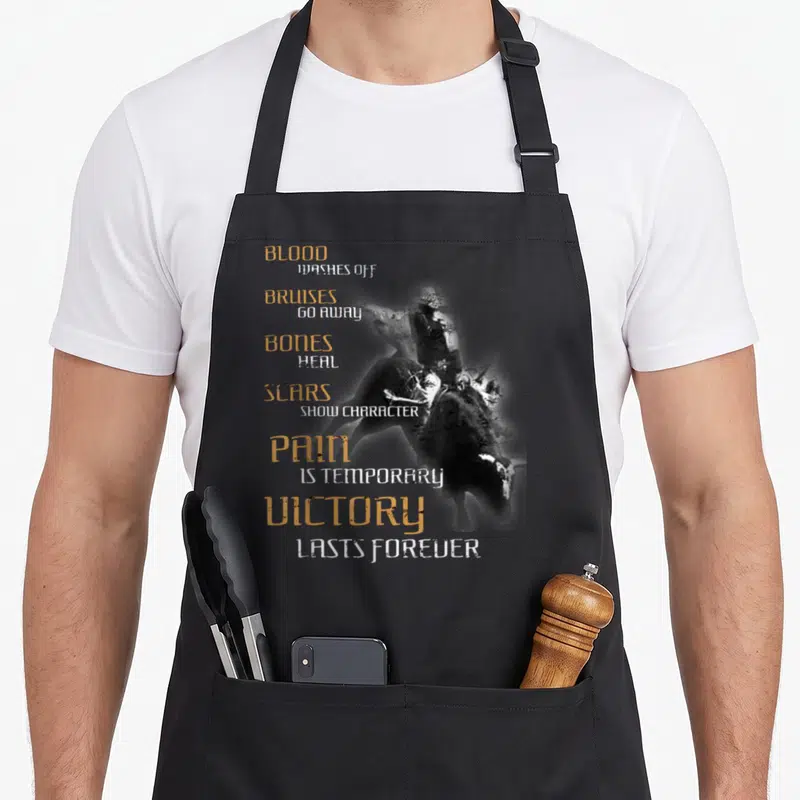 Bull western aprons - Stacked gold and white text reading blood washes off bruises go away bones heal scars show — shown on a black cotton canvas apron against a white background