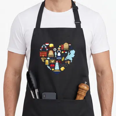 Netherland tulip apron - Heart shape formed by Dutch windmill, tulips, cheese, and bicycle icons in blue red yellow — shown on a black cotton canvas apron against a white background