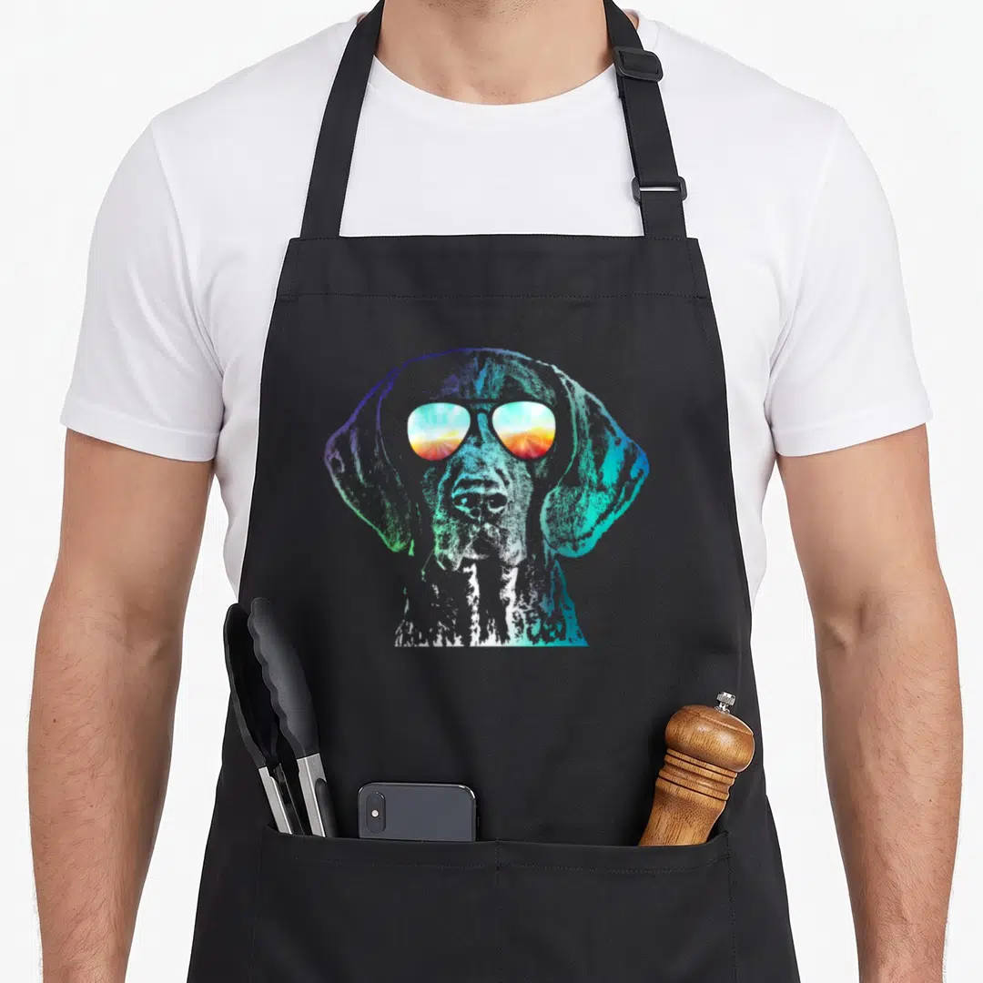 Disco german dog apron - Retro German Shorthaired Pointer head with sunset sunglasses in blue, green, purple, orange — shown on a black cotton canvas apron against a white background