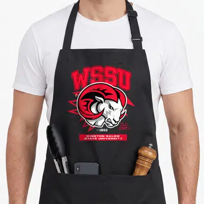 Salem ram apron - WSSU arched text, ram head, red burst, EST 1892, OLD STATE U, university banner — shown on a black cotton canvas apron against a white background