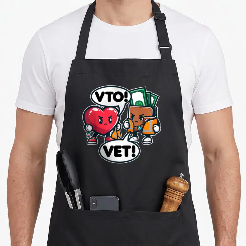 Swagazon vet apron - Red heart and brown wallet cartoon characters wearing safety vests with VTO and VET text bubbles — shown on a black cotton canvas apron against a white background
