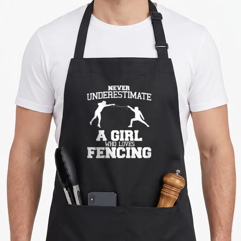 Underestimate fencing apron - White text and two fencer silhouettes on grey background — shown on a black cotton canvas apron against a white background