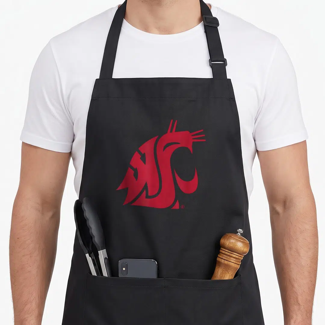 Washington state university apron - Red stylized cougar head logo centered on grey background — shown on a black cotton canvas apron against a white background