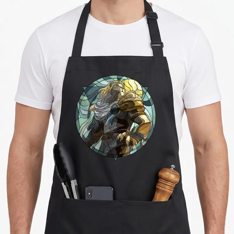 Ajani stained apron - Lion in stained glass style within circle, triangle, and moon using blue, gold, brown, and green — shown on a black cotton canvas apron against a white background