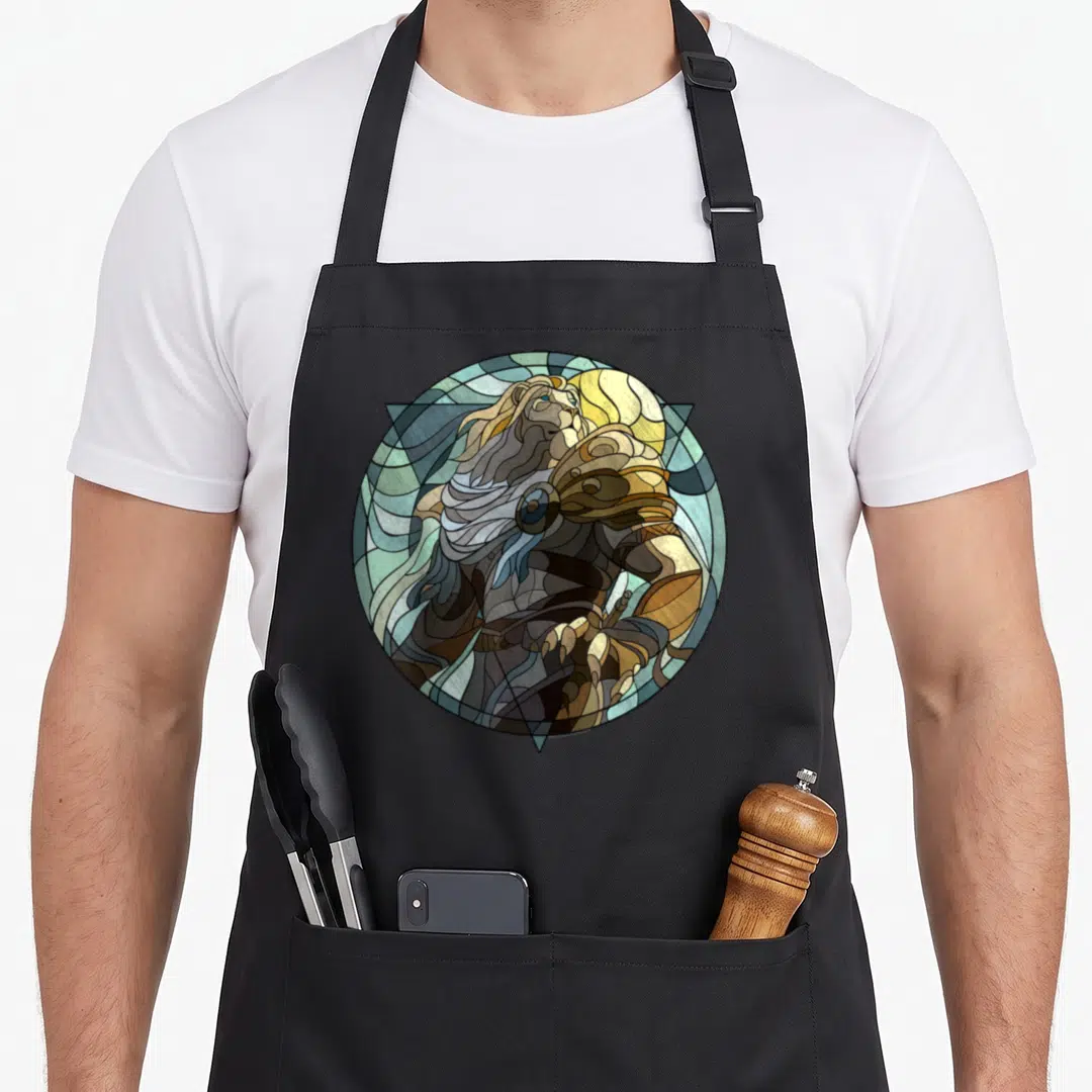 Ajani stained apron - Lion in stained glass style within circle, triangle, and moon using blue, gold, brown, and green — shown on a black cotton canvas apron against a white background