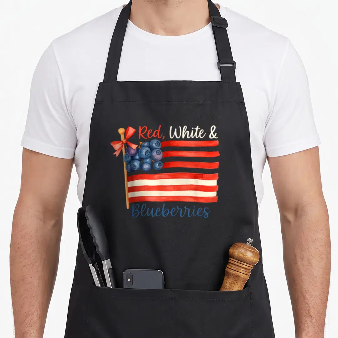 Blueberry american flag apron - Watercolor flag with blueberries replacing stars and red, white, and blueberries text — shown on a black cotton canvas apron against a white background